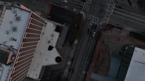 Overhead-aerial-view-of-Atlanta-city-road-with-empty-parking-lot-nearby,-Georgia,-USA