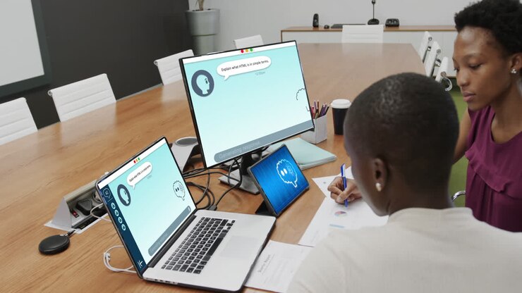 Composition of diverse businesswomen using laptop with ai chat on screen