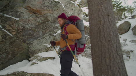 hiker going down steep rocky trail on winter day