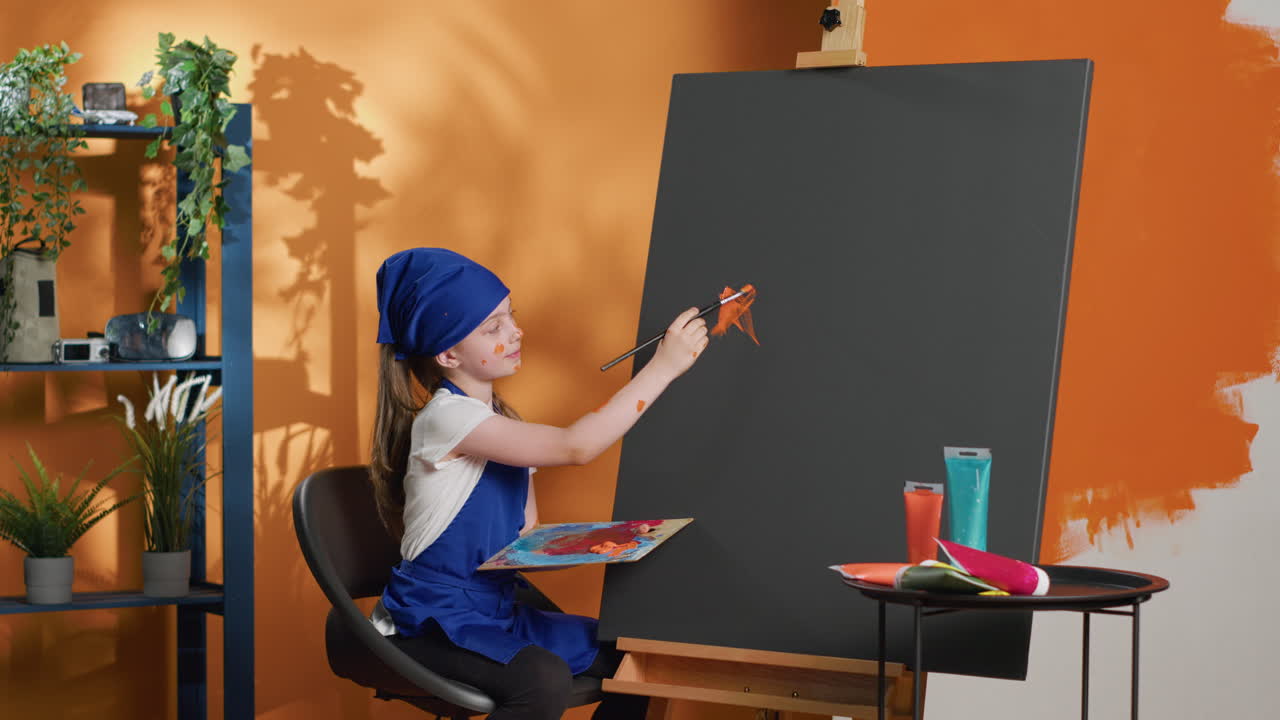 Young girl painting on a canvas in an art studio