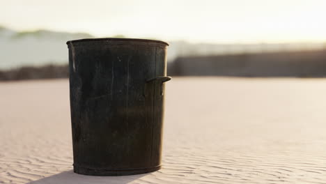 gray metal garbage bin or trash can on the beach