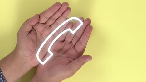 hands of a person opening themselves and animation of a call symbol appearing on them