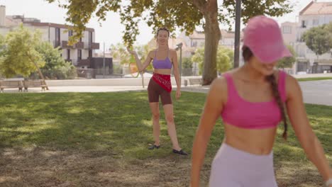 two women playing sports in a park