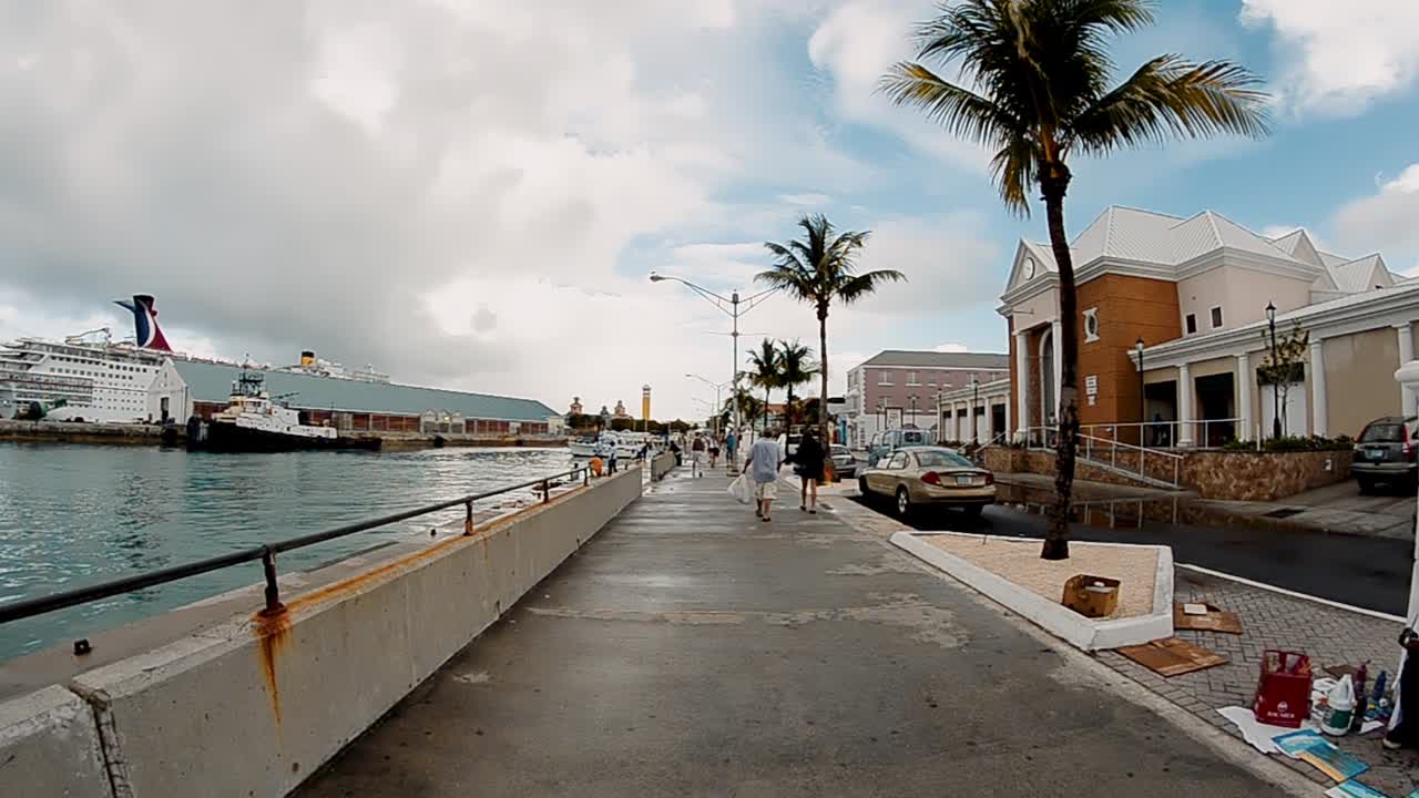 NASSAU, BAHAMAS - FEBRUARY 2012: Walking along city streets on a beautiful day. Slow motion.