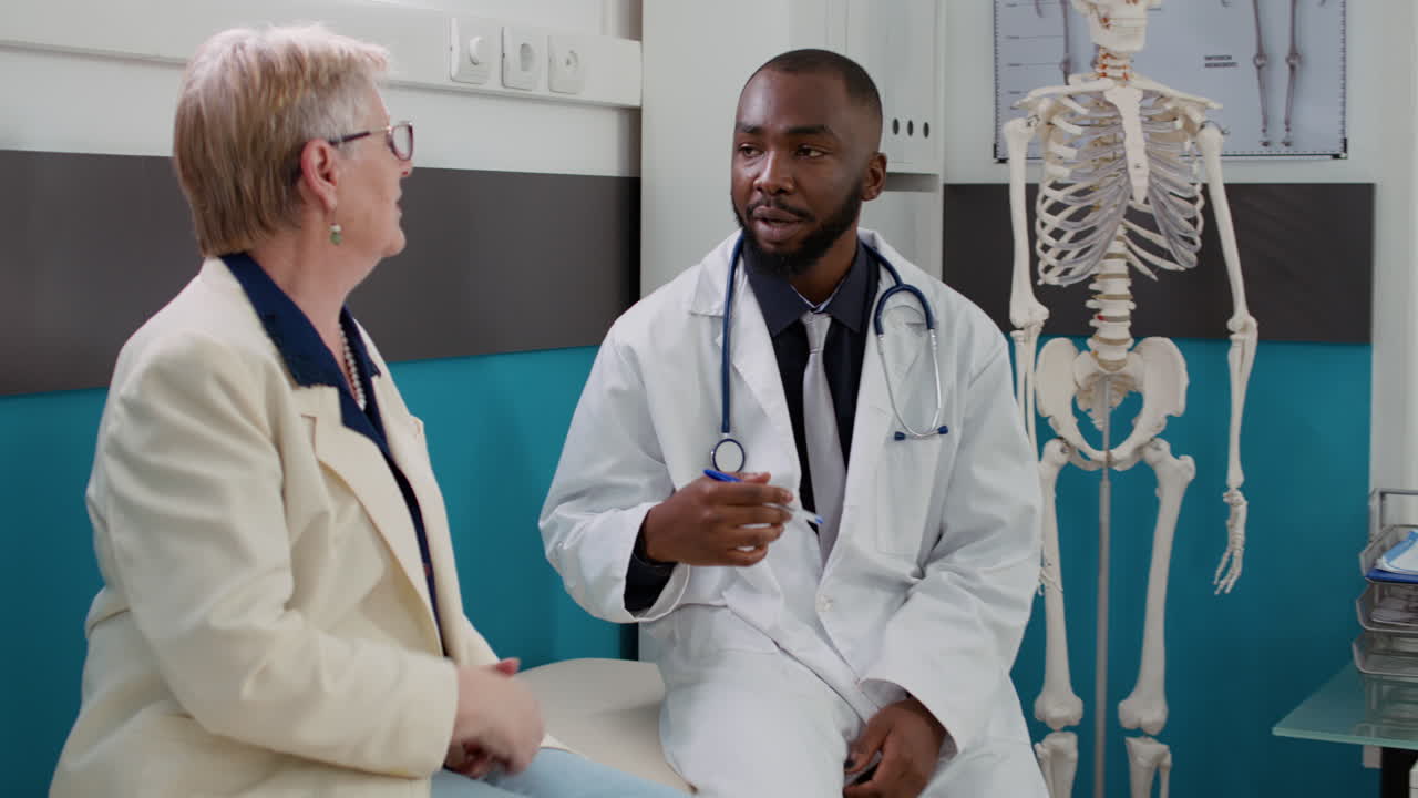 Doctor consulting with elderly patient in medical office