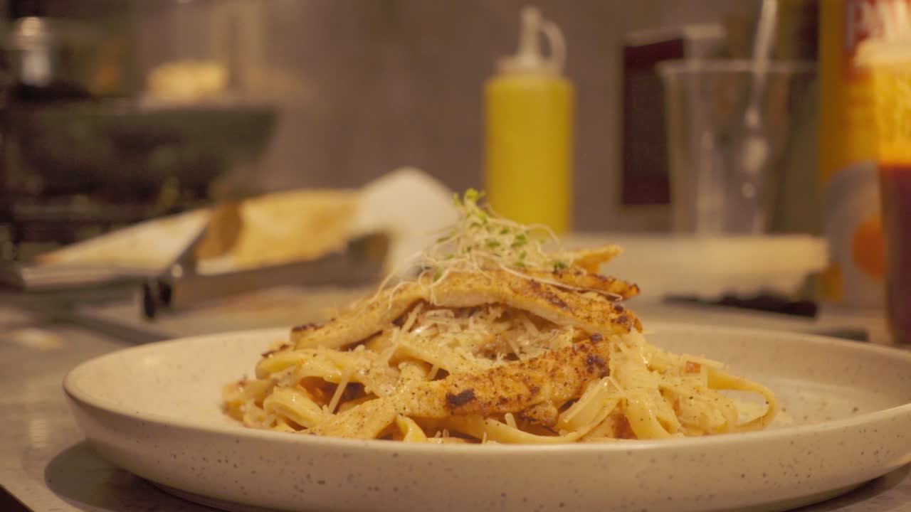 Delicious pasta dish with grilled chicken and herbs, perfect for dining joy