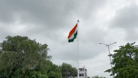 wide shot of india flag waving in slow motion on cloudy sky
