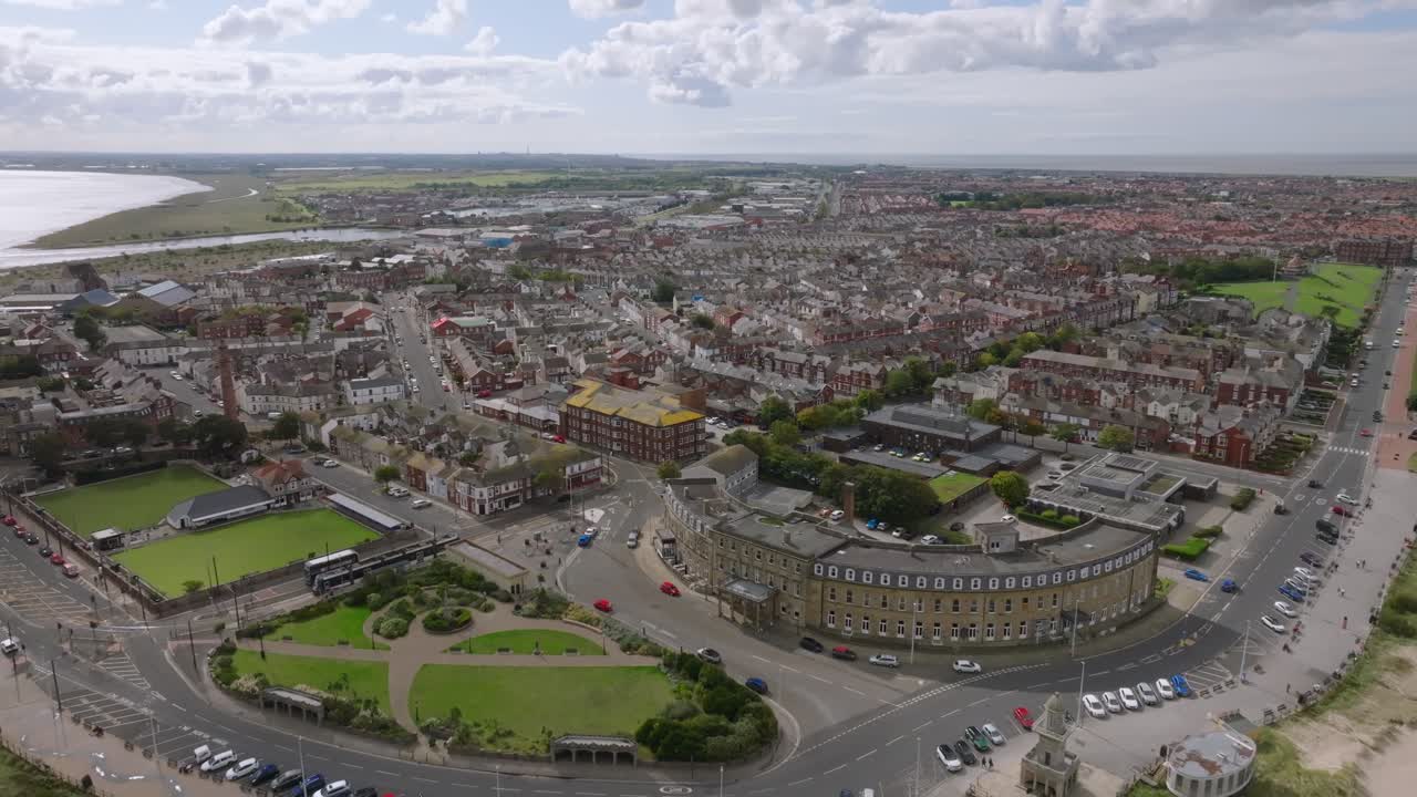 The Curved North Euston Hotel On Fleetwood Headland. Camera Flight Over Beach And Over Urban Area. Lancashire, UK