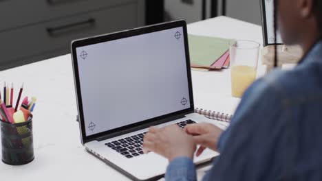 African-american-teenage-girl-studying-at-home-using-laptop-with-copy-space-on-screen-in-slow-motion