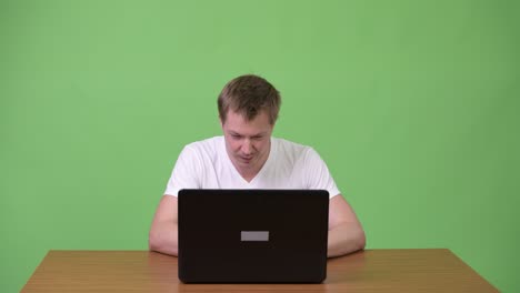 young man using laptop with young asian businesswoman getting angry
