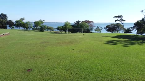 drone camera going through the soccer goal of the football ground