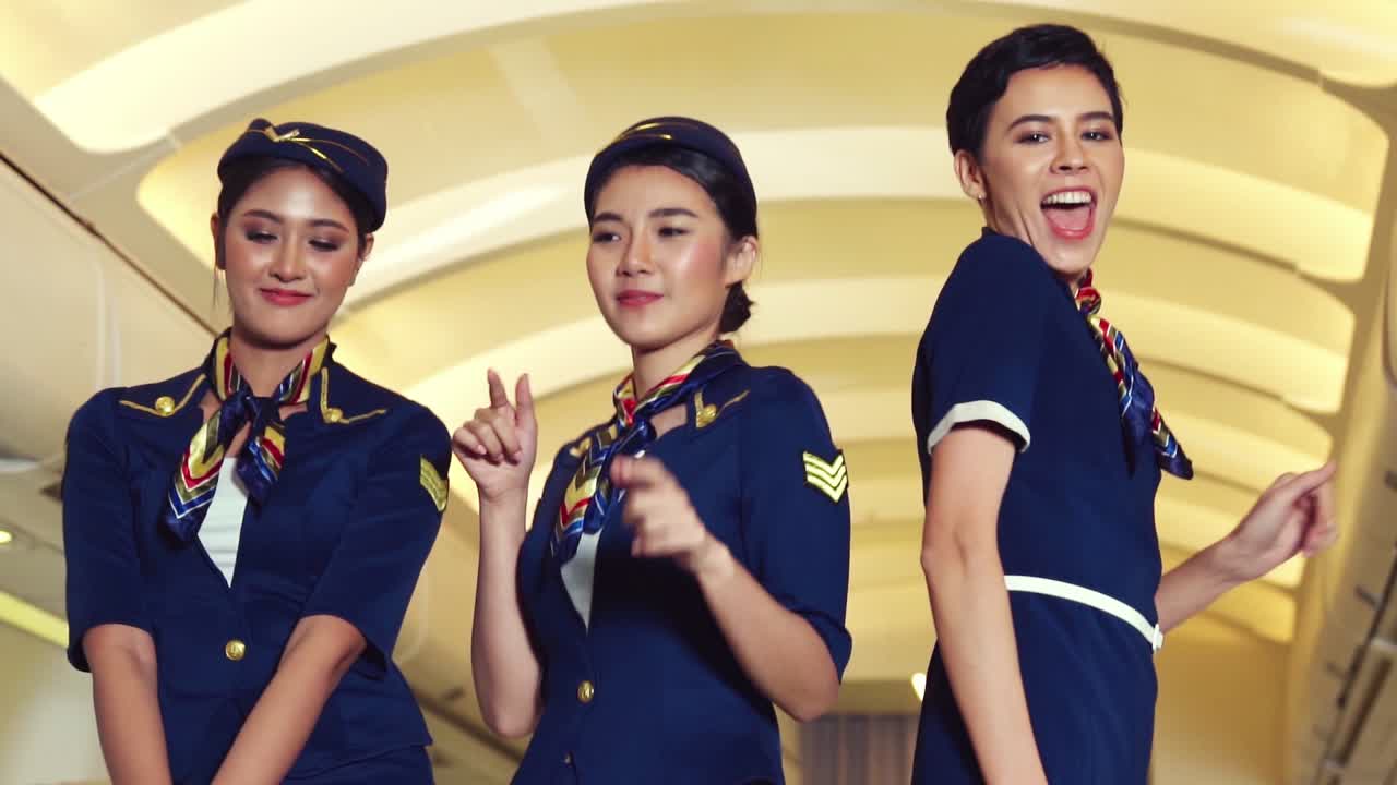 Premium stock video - Cabin crew dancing with joy in airplane