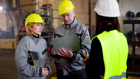 three workmates talking at the factory