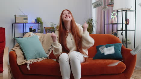 money cash dollar rain falling on girl celebrating success winning good news lottery jackpot luck