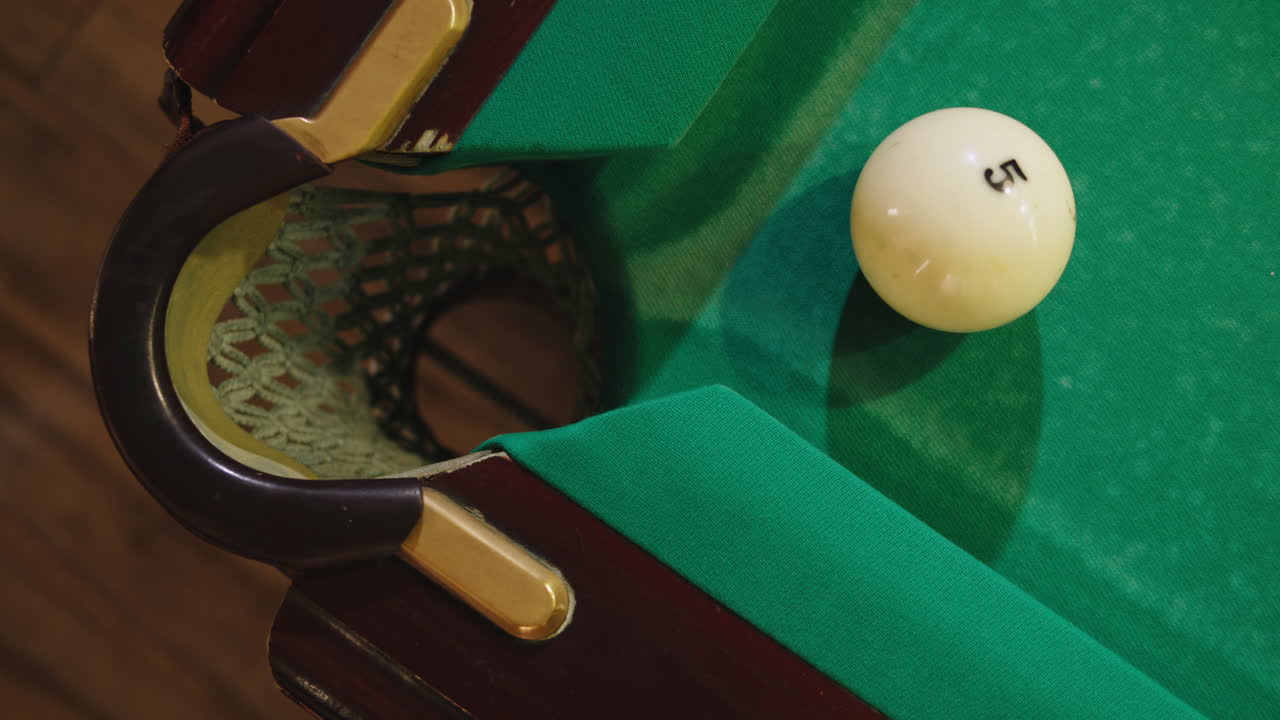 Playing billiard game. White pool balls close-up on green billiards table for start to play. Russian game, Russian pyramid. Billiard balls with numbers on a pool table. Billiards team sport.High quality 4k footage