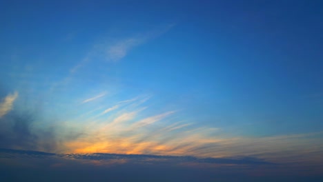 panoramic fiery golden cirrus clouds on blue gradient sky