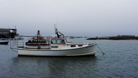 Lobster-fishing-boat-drone-shot-revealing-marina-with-boats-and-pier-HD-30p