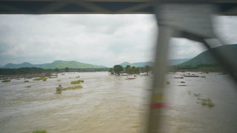 Driving-on-a-bridge-over-a-big-overflowing-river---2