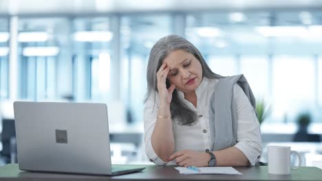 stressed and tensed indian senior businesswoman