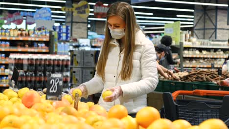 girl buys lemon in the supermarket, citrus, healthy food. vitamin c, natural vitamins