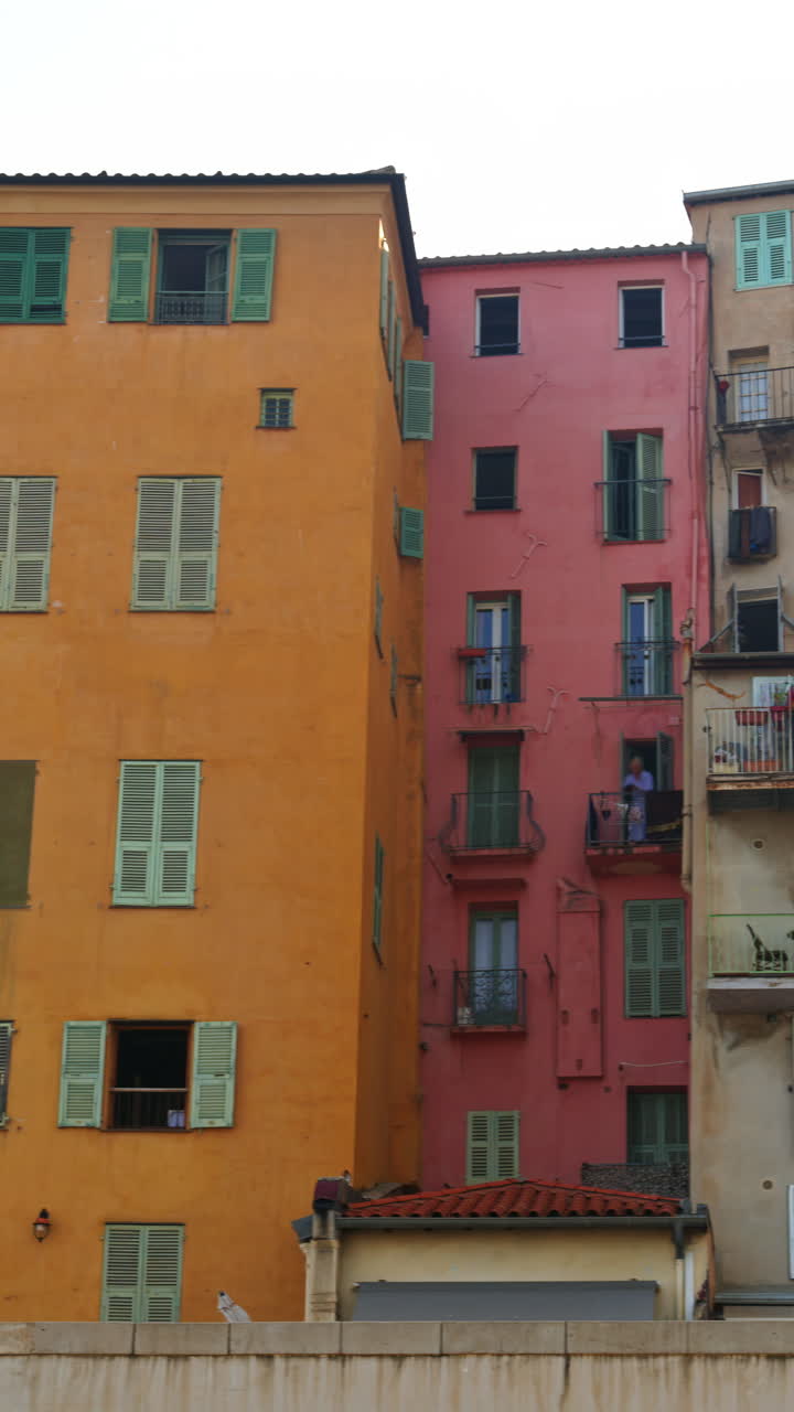 View of the colourful buildings in Menton, France. Vertical
