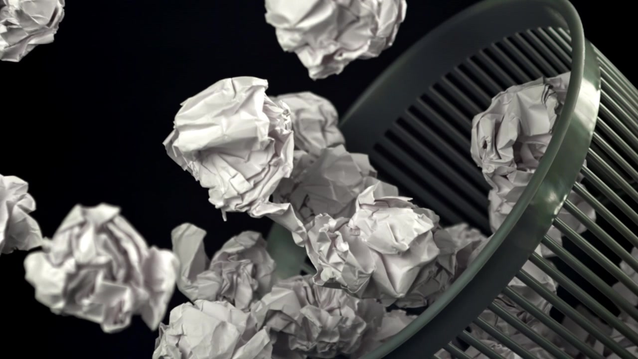 Crumpled Paper Falling Out of an Overturned Wastebasket in Slow Motion
