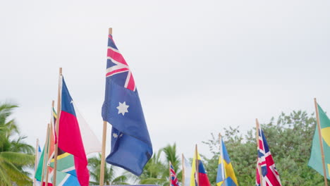 Line-Of-Many-National-Country-Flags-Blowing-In-Wind-On-Cloudy-Day,-4K-Slow-Motion