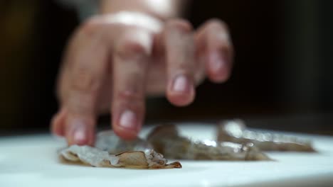 Mexican-Latin-cooker-Chef-slicing-fresh-shrimps-in-to-half-butterfly-cut-close-up