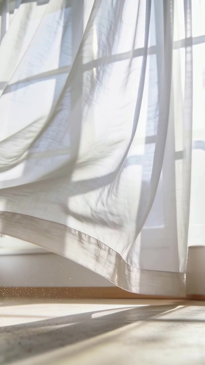 Vertical video: Swaying sheer curtain moving across home window, breeze causing moving grid shadows