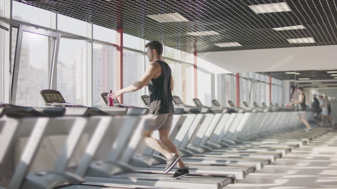 Run workout in gym. Man training exercise on treadmill. Running man