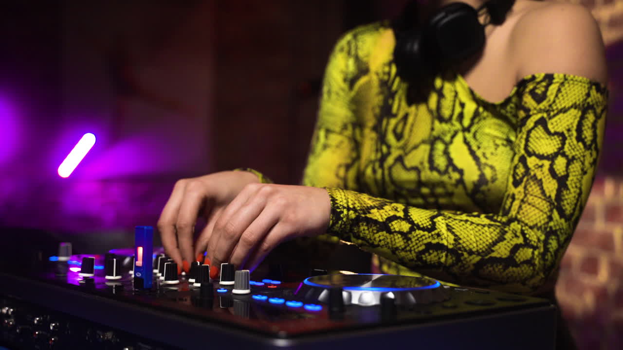 Woman with headphones djing at the disco