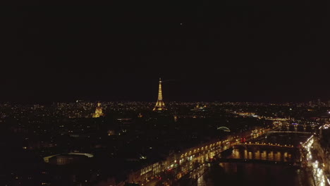 Amazing-aerial-night-panoramic-footage-of-city.-Illuminated-Seine-river-waterfronts-and-Eiffel-Tower.-Paris,-France