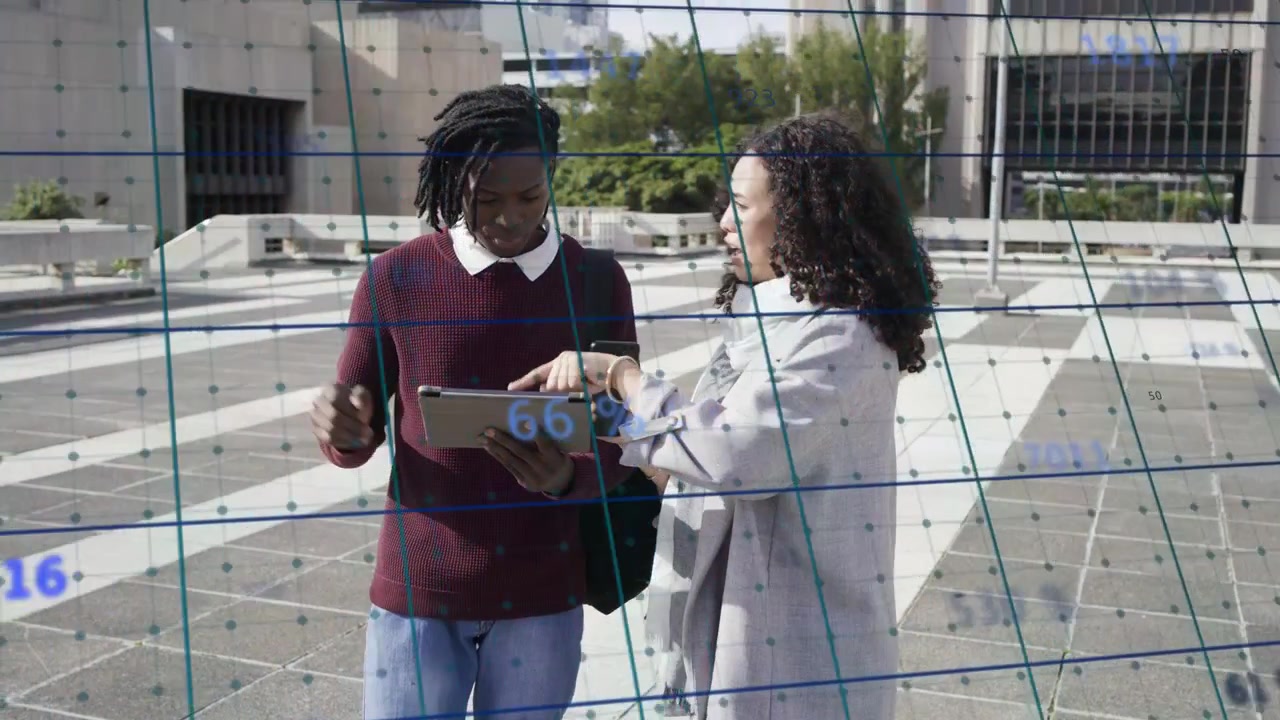 Man tapping tablet while woman pointing phone, showing faint grid and percent data, tech agreeing