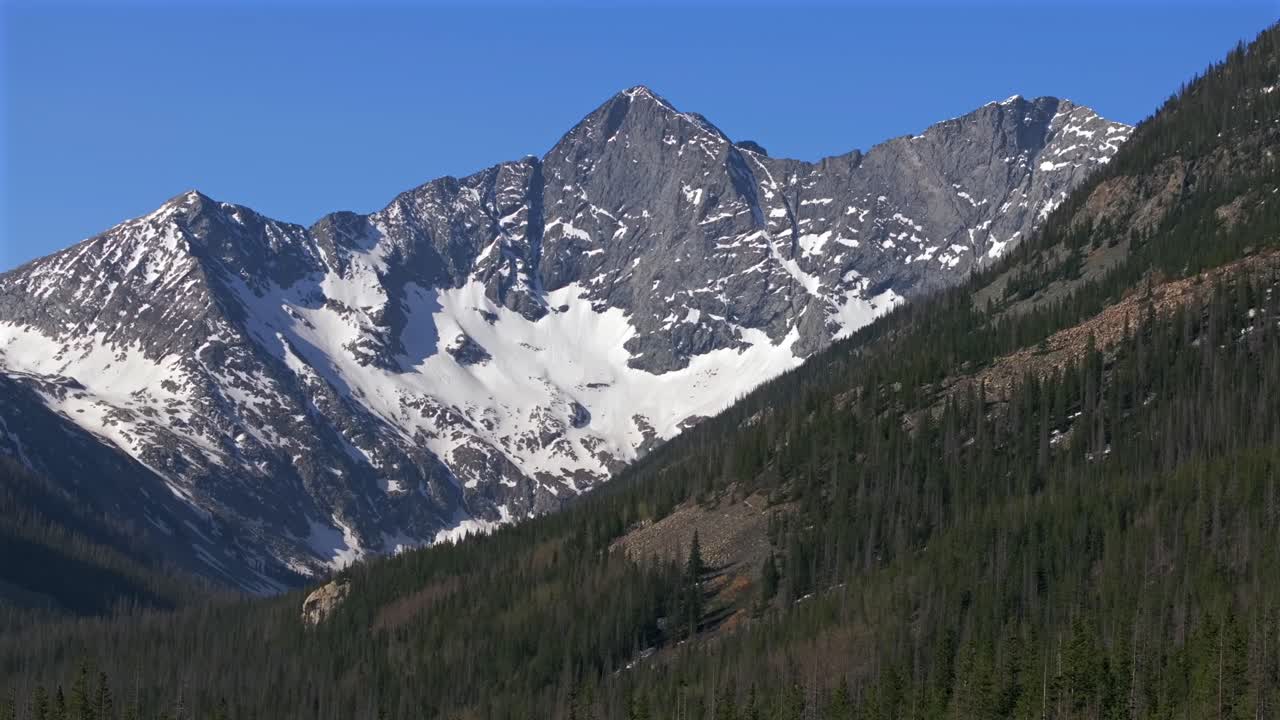 Blanca Peak mount Lindsey Sangre de Cristo Range aerial drone Colorado Rocky Mountains San Isabel National Forest Lily Lake trail sunny morning blue skies spring summer snow fields pan left