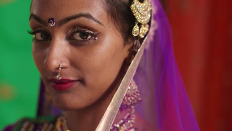 close up portrait of female kathak dancer performing dance wearing traditional indian dress and jewellery looking at camera 1