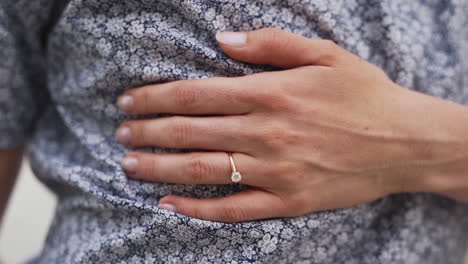 close up of a beautiful engagement ring on a young woman's finger