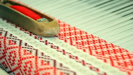 woman hands working on weaving machine. process of fabric production