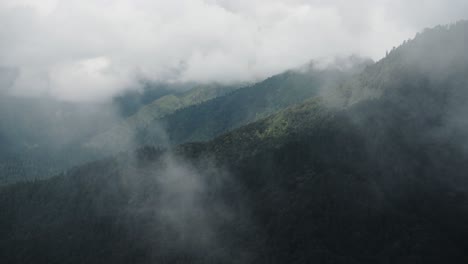 Cloud-Moving-Through-Valley-in-Mountains-in-the-Himalayas-in-Nepal,-Trees-and-Forest-Landscape-Scenery-from-Above-in-Annapurna-Region-on-Nepal