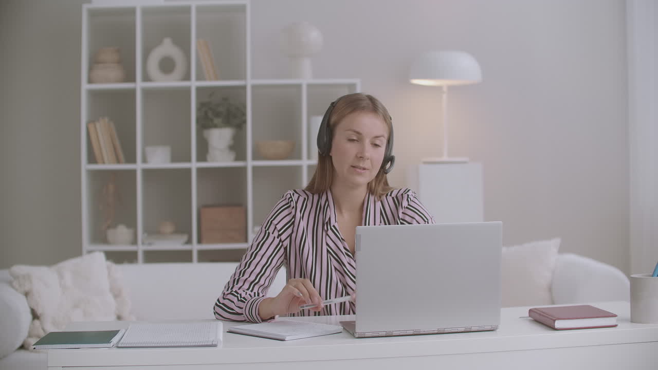 female student is giving exam of foreign language online talking by video chat on laptop distant mode