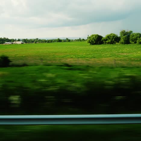 view from the window of a moving bus or car along the picturesque fields and farms of europe