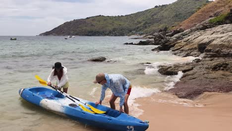 couple kayaking on a tropical beach