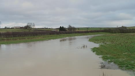 river flooding in rural farmland