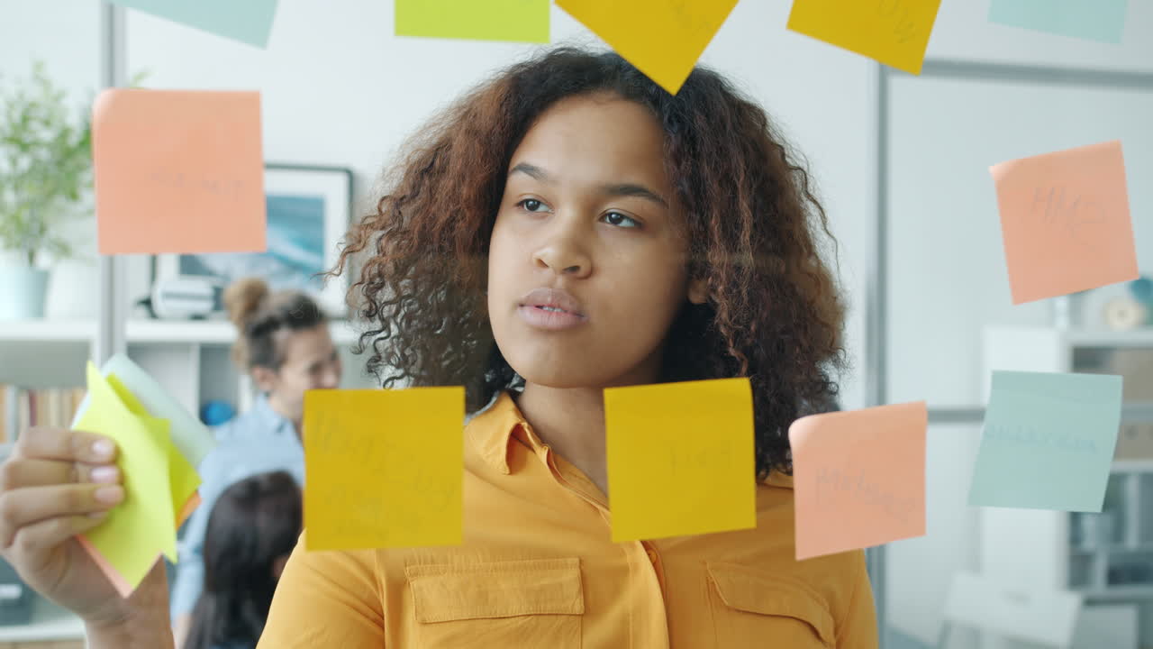 Woman Brainstorming with Sticky Notes