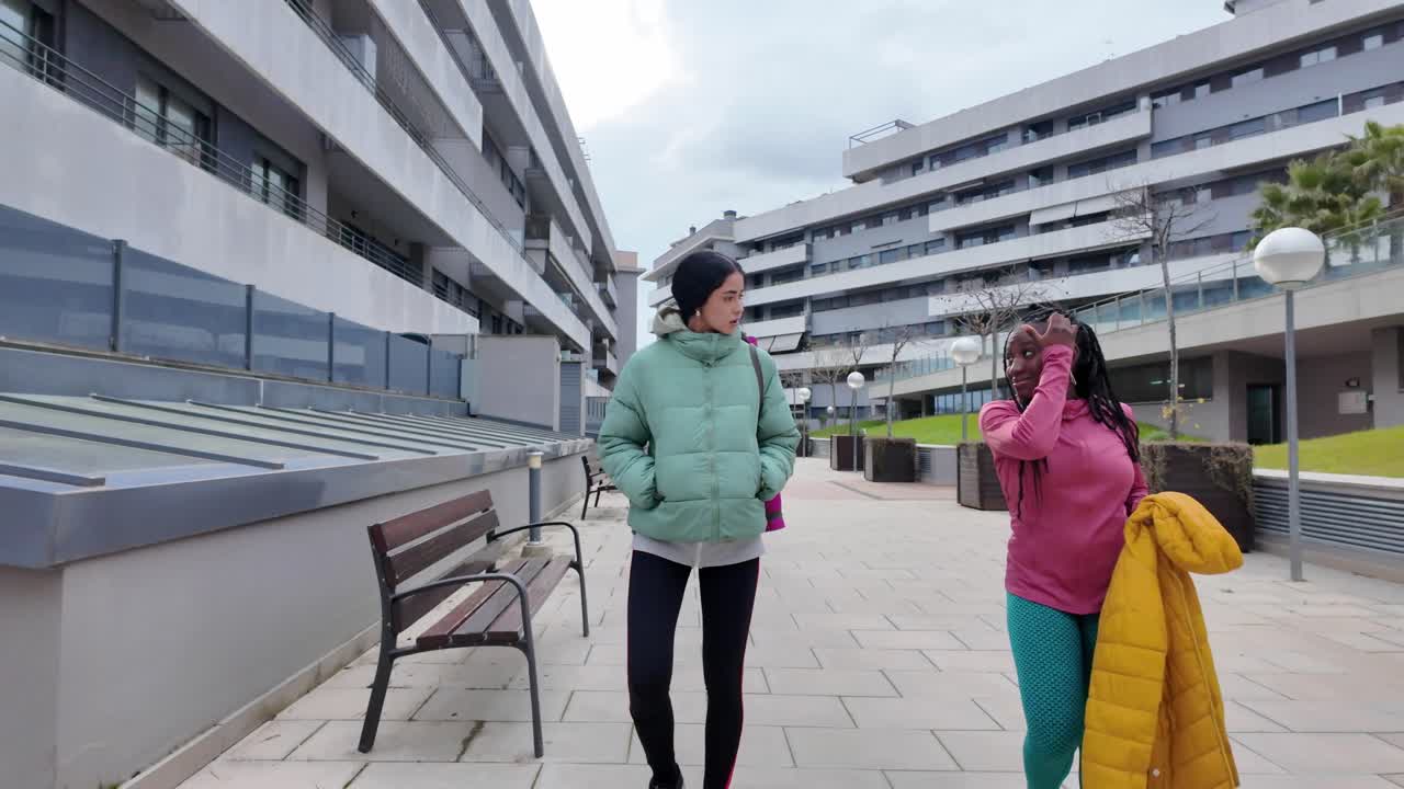 Two women walking outdoors in the city