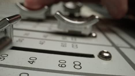 close-up of a hand operating an audio mixer