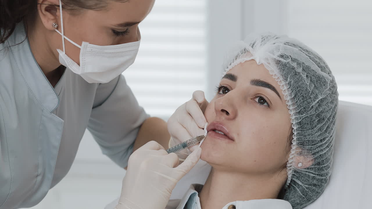 Woman receiving lip injection from a medical professional