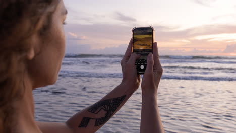 mujer tomando una foto de la playa