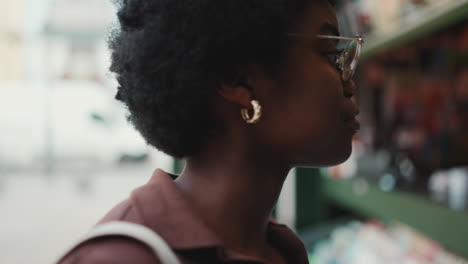 beautiful african woman wearing earrings walking outdoors