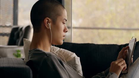 man listening music while using digital tablet at home 4k