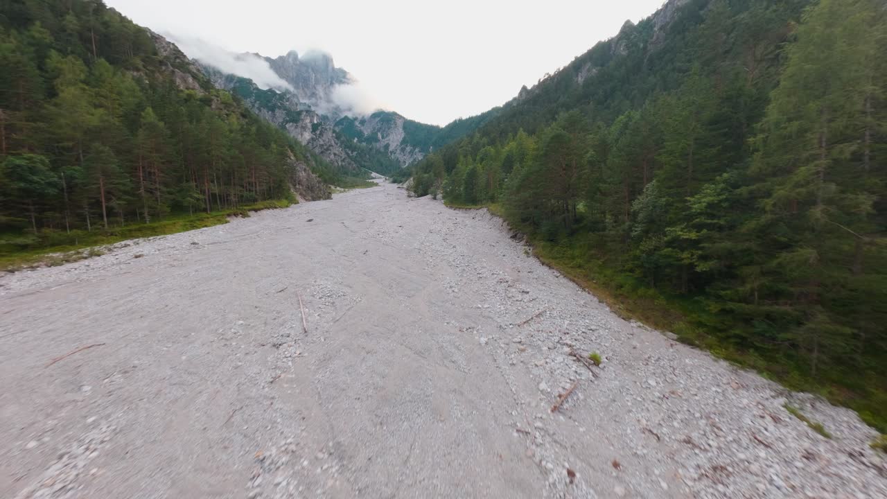Environmental crisis in the Alps, FPV drone view of dry river channel